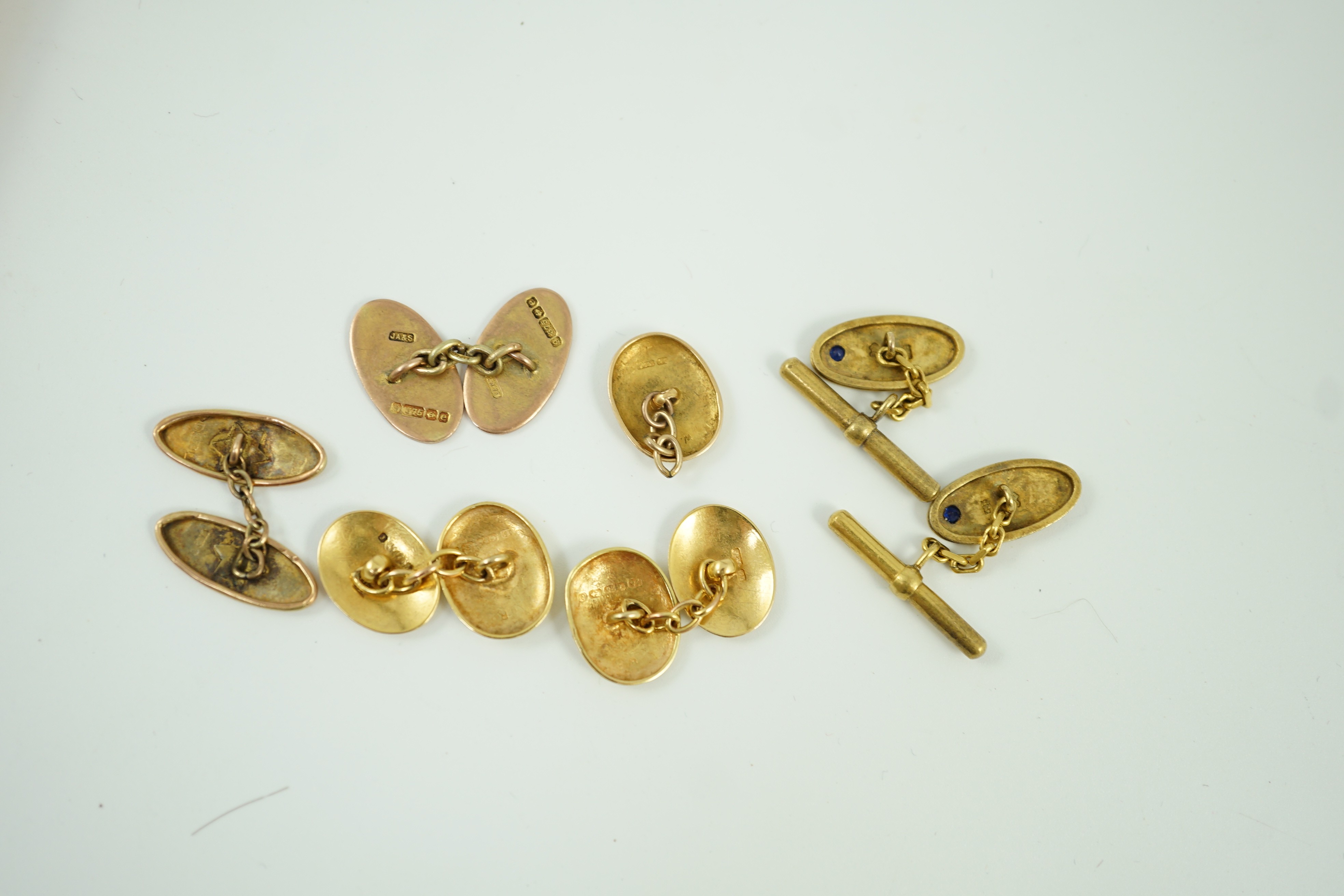 A pair of late Victorian engraved 15ct gold oval cufflinks, one other similar link section only, 6.7 grams, a pair of gem set 585 cufflinks, gross 6.5 grams and two 9ct gold cufflinks, 5.9 grams.